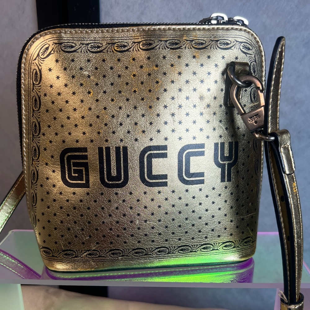 Gucci Limited Edition GUCCY x SEGA video game gold & black dome crossbody bag.